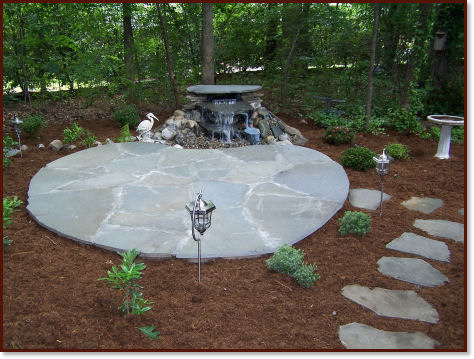 low voltage lighting fixture next to stone patio